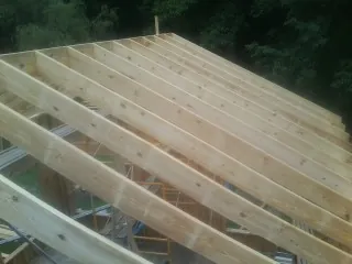 New roof rafters set over an addition before sheathing in Waterloo